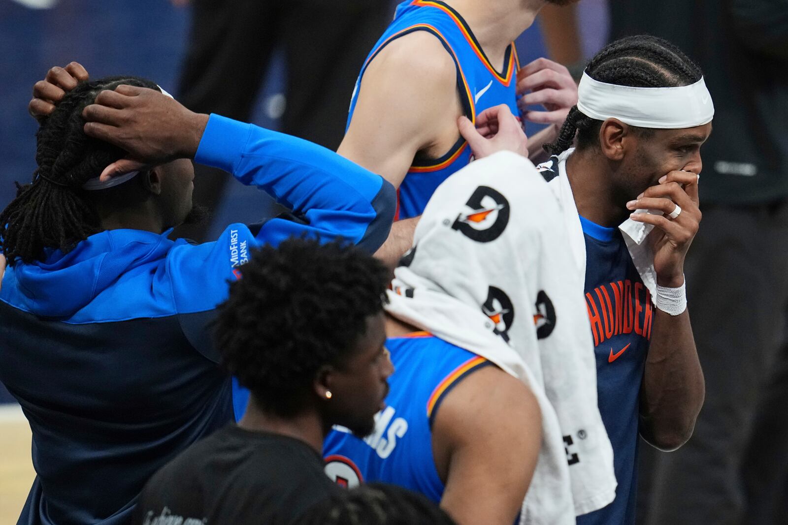Oklahoma City Thunder guard Shai Gilgeous-Alexander, right, stands with teammates during a timeout during the second half of Game 6 of the NBA Finals basketball series against the Indiana Pacers, Thursday, June 19, 2025, in Indianapolis. (AP Photo/Michael Conroy)
