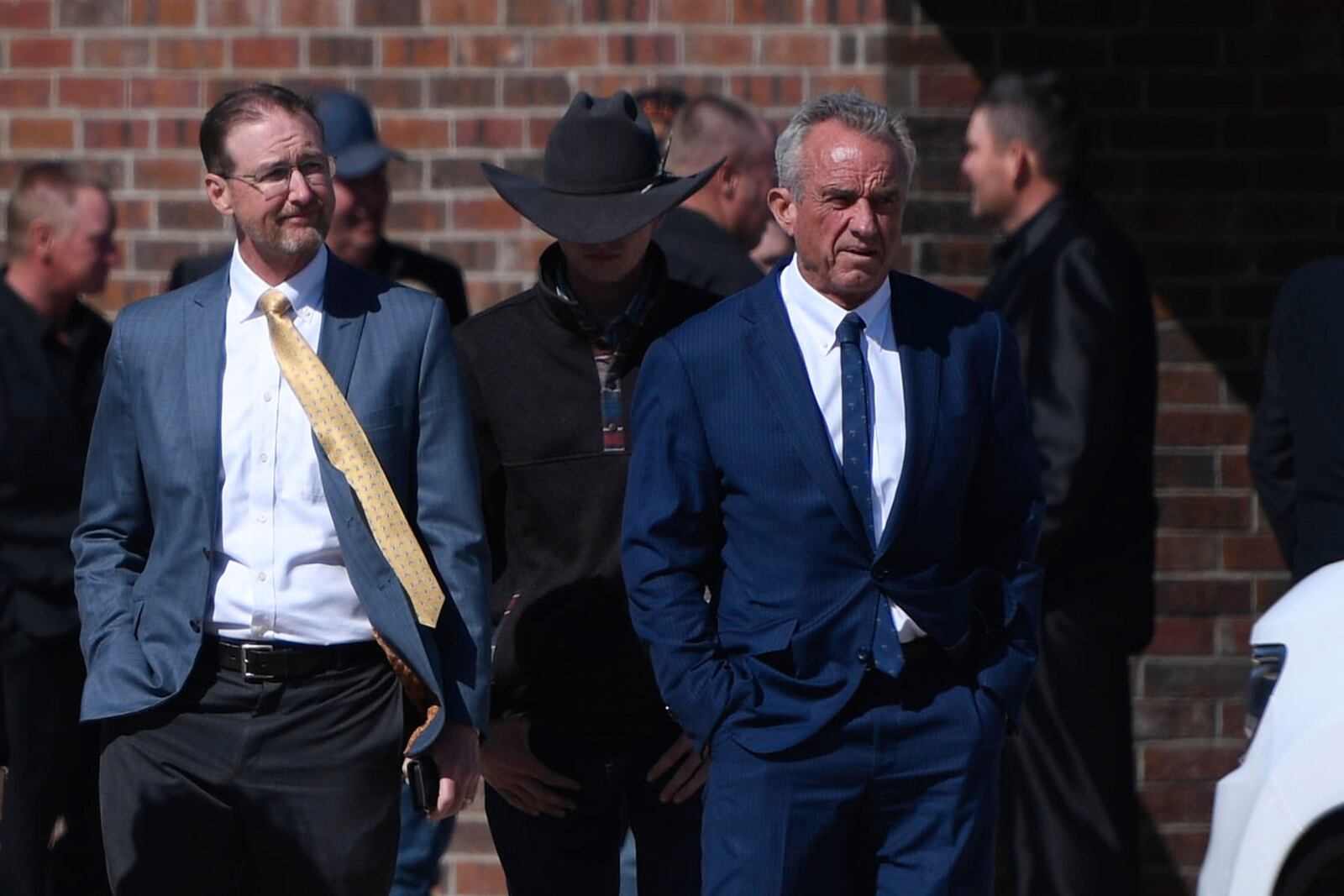 Health and Human Services Secretary Robert F. Kennedy Jr., right, arrives at Reinlander Mennonite Church after a second measles death, Sunday, April 6, 2025, in Seminole, Texas. (AP Photo/Annie Rice)