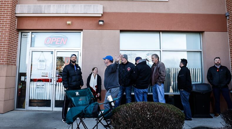 Customers wait in the cold to buy limited allocated bourbon at Centerville Liquor & Wine on South Mian Street in Centerville Friday, Feb. 24, 2023. Total sales of liquor increased in Ohio in 2022 by nearly 1%, while the amount of gallons sold decreased by nearly 1.8%. JIM NOELKER/STAFF