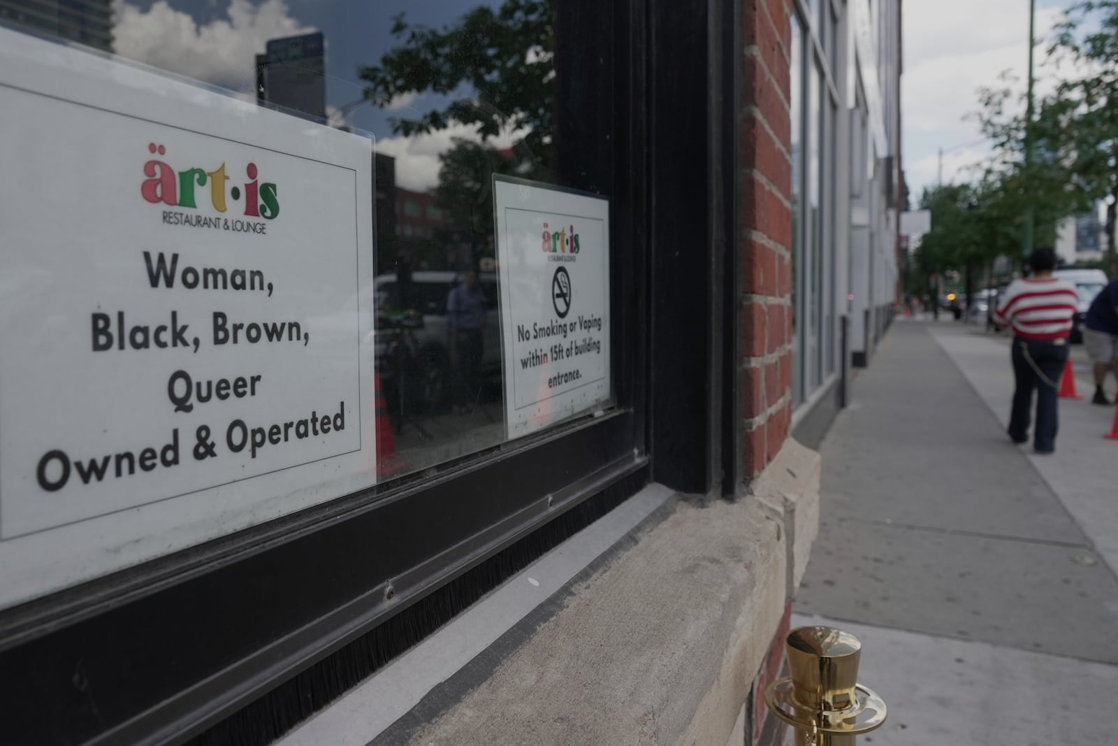 People walk by Artis Restaurant and Lounge in Chicago on Thursday, July 3, 2025. (AP Photo/Laura Bargfeld)