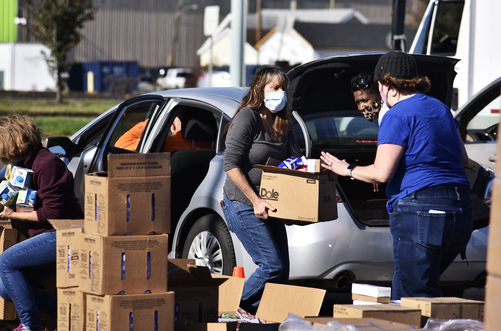 More than 100 cars lined up in Hamilton Friday to receive free food boxes as part of senior program sponsored by Shared Harvest food bank in Fairfield. More than 300 seniors who had signed up for the food giveaway came through the distribution center set up in a shopping center parking lot along Route 4 in Hamilton. (Photo By Nick Graham\Journal-News)