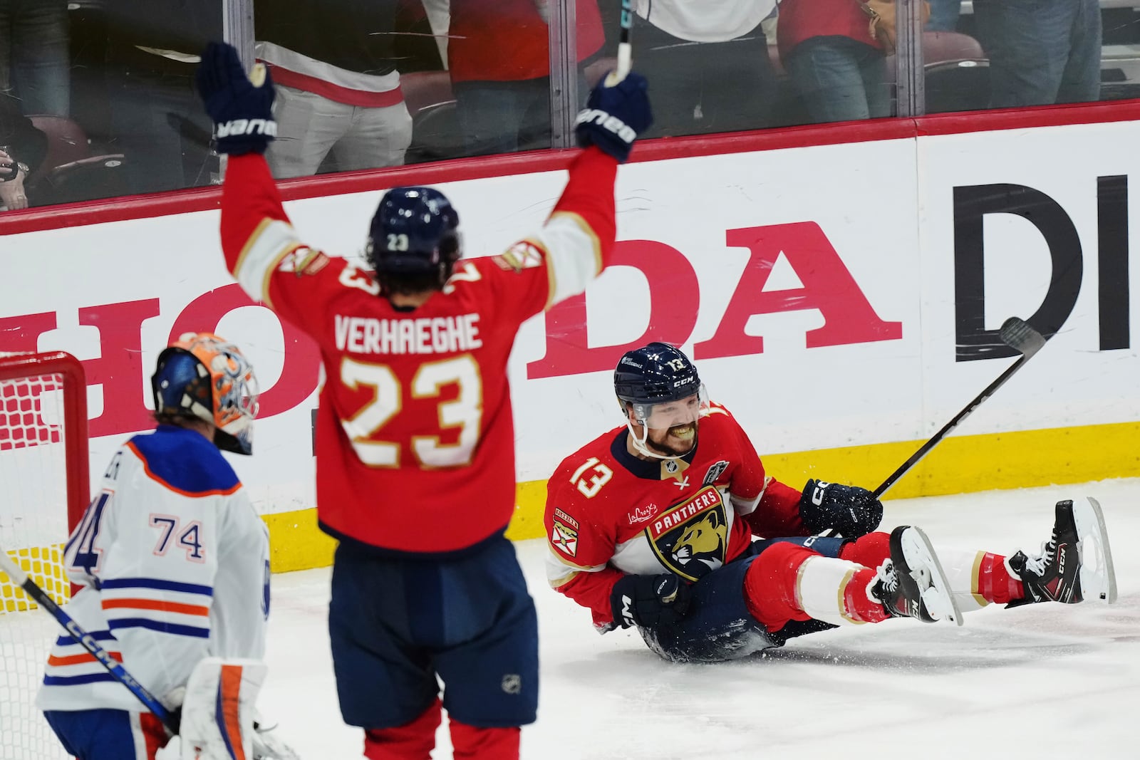 Florida Panthers' Sam Reinhart (13) celebrates his goal against Edmonton Oilers goalie Stuart Skinner (74) as Panthers' Carter Verhaeghe (23) reacts during the first period in Game 6 of the NHL hockey Stanley Cup Final in Sunrise, Fla., Tuesday, June 17, 2025. (Nathan Denette/The Canadian Press via AP)