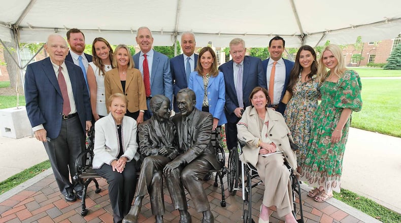 The Farmer Family Sculpture Park was dedicated earlier this month on Miami University’s main Oxford campus featuring a bronze sculpture of Richard (Dick) and Joyce Farmer. Dick Farmer, who died in 2021, was founder of the Fortune 500 Cintas Corporation and gave the Miami business school its name. The couple are financial donors to the school. Joyce Farmer is seated and surrounded by family members. CONTRIBUTED