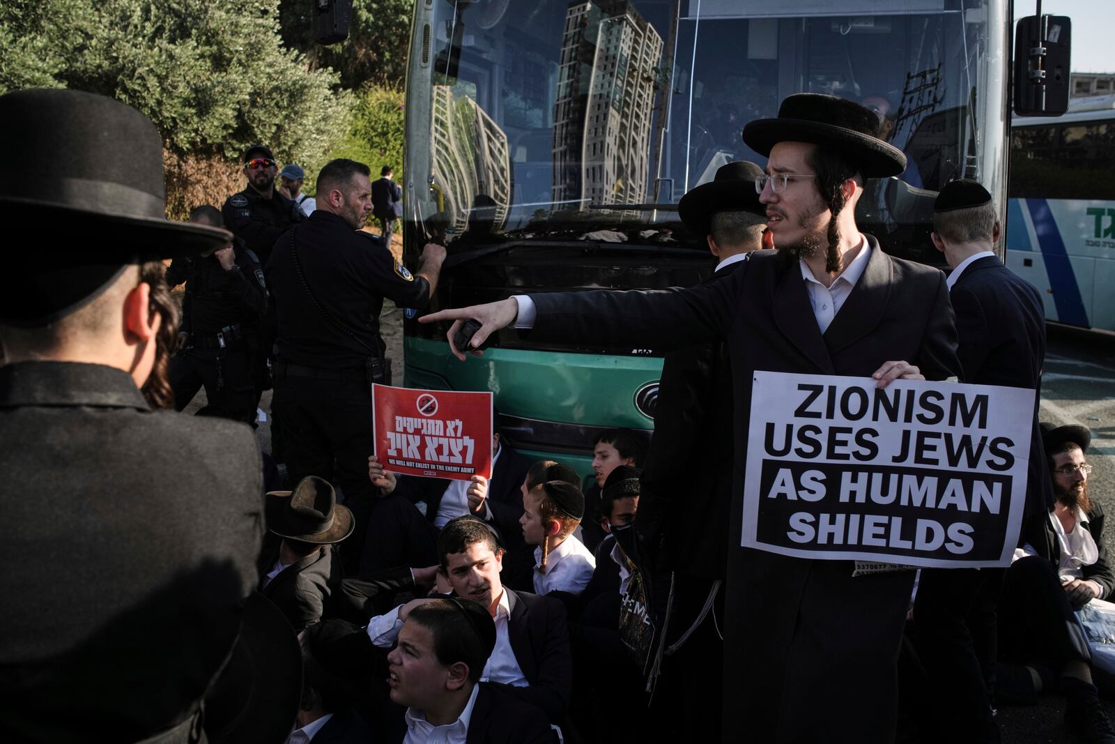Ultra-Orthodox Jewish men block a highway during a protest against army recruitment in Bnei Brak, Israel, Thursday, June 5, 2025. (AP Photo/Leo Correa)