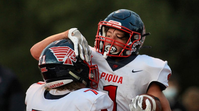 Piqua's Jacob Hepner and Tanner Kemp celebrate a touchdown run by Kemp against Tippecanoe on Friday, Sept. 25, 2020, in Tipp City. David Jablonski/Staff