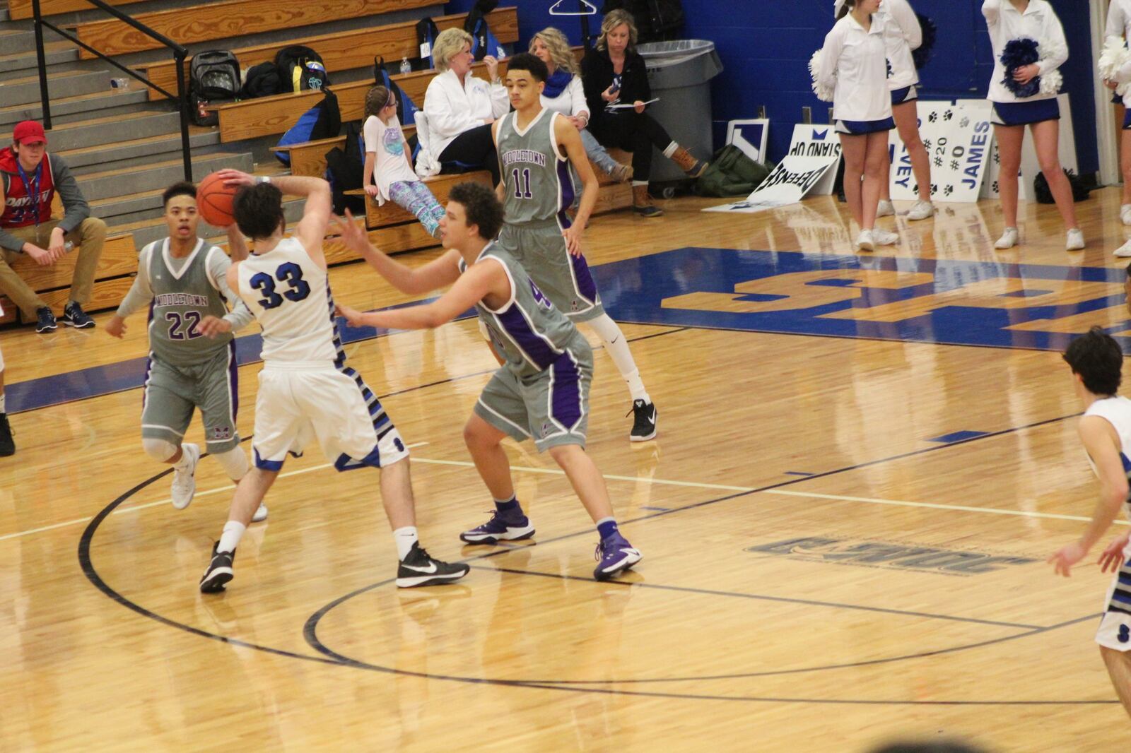 Springboro’s Thomas Arrington (33) is surrounded by Middletown’s Christian Strother (22), Cliff Snow (11) and Chris Stallworth (40) during Saturday night’s game at Springboro. CONTRIBUTED PHOTO BY MARITZA MCKINNEY