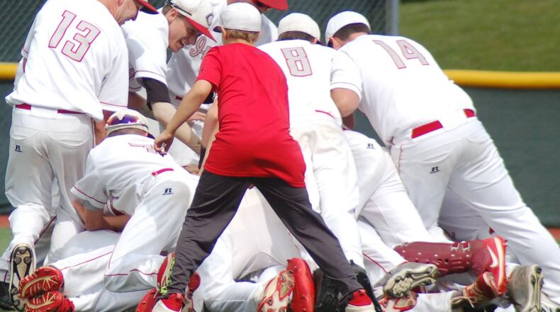 Carlisle’s players celebrate on the field Thursday after defeating Cincinnati Country Day 2-0 in a Division III regional semifinal at the Athletes in Action complex in Xenia. CONTRIBUTED PHOTO BY JOHN CUMMINGS