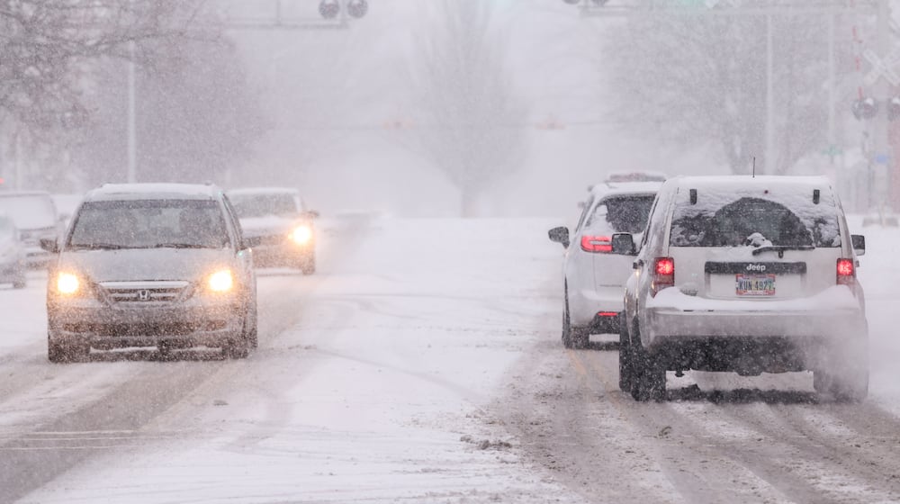 Vehicles drive on East Main Street in Troy on Saturday, Dec. 13. Up to six inches of snow was expected in parts of the area. BRYANT BILLING/STAFF