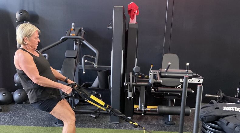 Marcy Schade pulls a weight sled stacked with 525 pounds across the fitness room floor. CONTRIBUTED