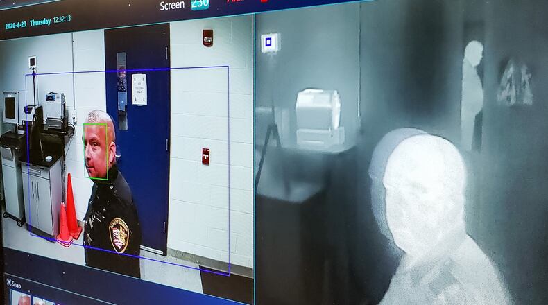 Butler County Sheriff’s deputy Ed Asher demonstrates a new thermal imaging camera in the booking area of the Butler County Jail Thursday, April 23, 2020 in Hamilton. The camera is capable of scanning temperature and taking a photo of people entering the jail. NICK GRAHAM / STAFF