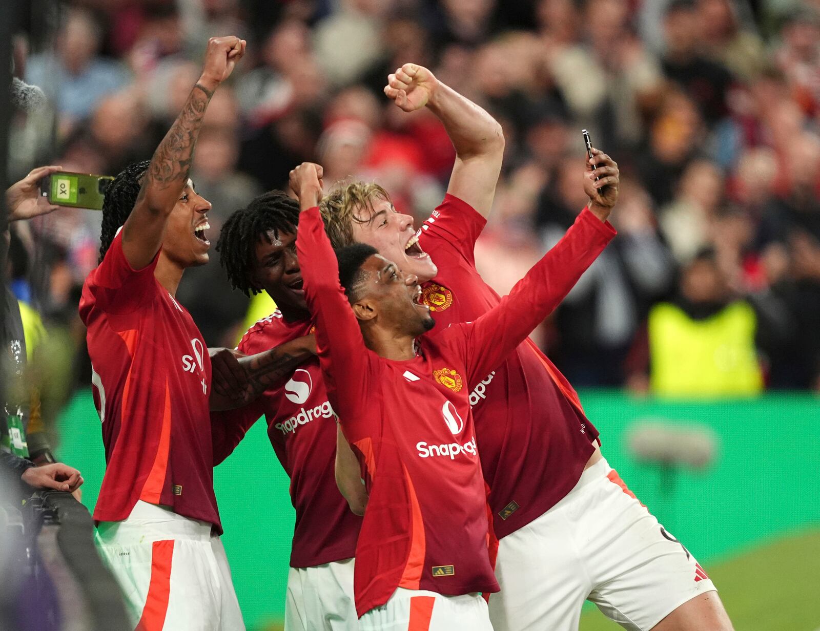 Manchester United's Rasmus Hojlund, back right, celebrates with teammates after scoring their side's third goal of the gameduring the Europa League semifinal second leg soccer match between Manchester United and Athletic Bilbao in Manchester, Britain, Thursday, May 8, 2025. (Martin Rickett/PA via AP)