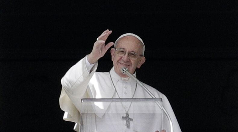 Pope Francis waves to faithful during the Angelus prayer delivered by Pope Francis in St. Peter’s Square at the Vatican, Sunday, March 5, 2017. The pontiff has called on the faithful to consult the Bible with the same frequency as they might consult their smart phones for messages. (AP Photo/Gregorio Borgia)