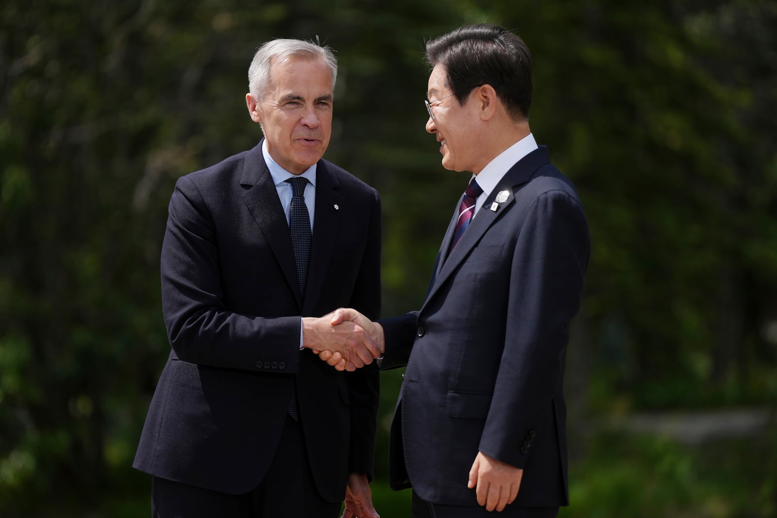 Canadian Prime Minister Mark Carney welcomes South Korean President Lee Jae-myung to the G7 Summit in Kananaskis, Alberta, Canada on Tuesday, June 17, 2025. (Darryl Dyck/The Canadian Press via AP) /The Canadian Press via AP)