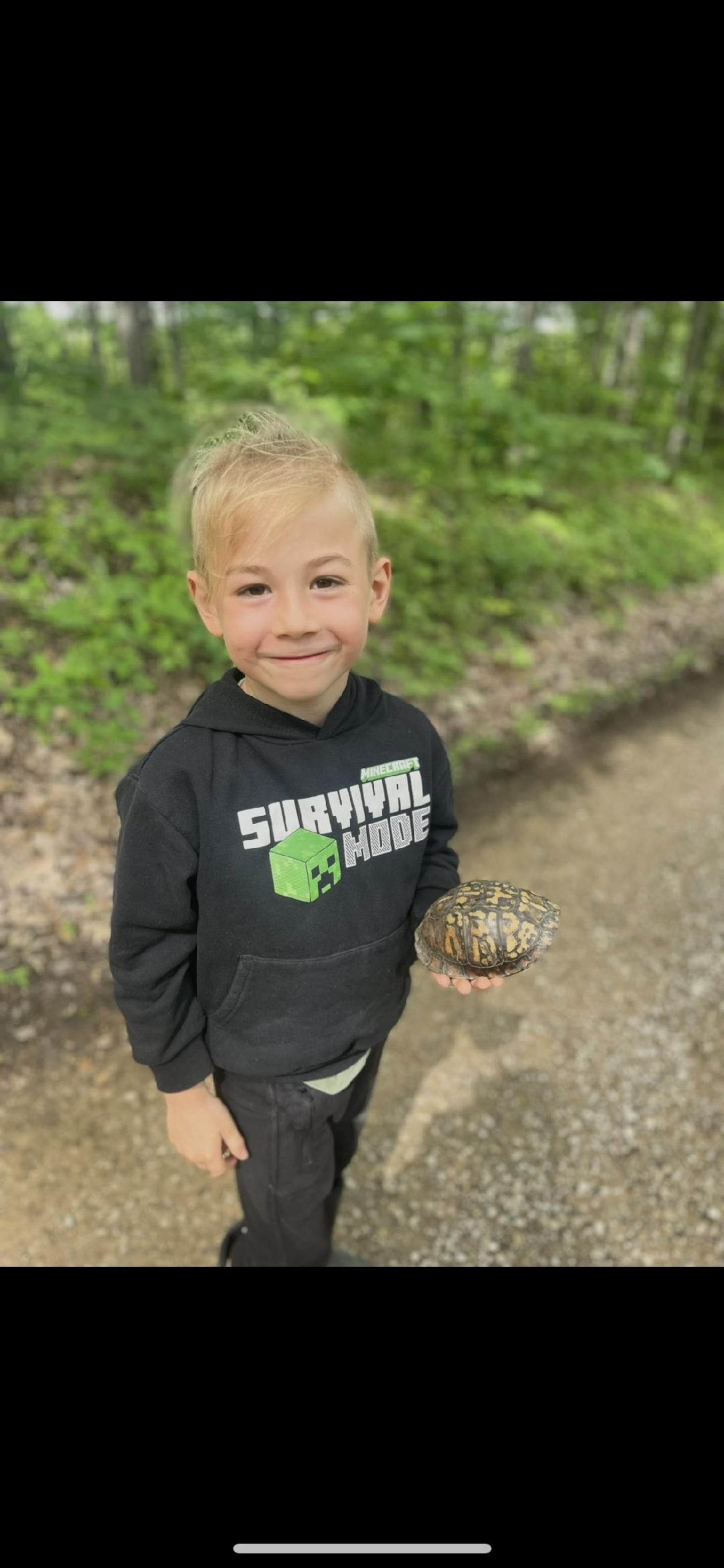 Kirk Wilson moving a turtle off the driving trail to safety. CONTRIBUTED