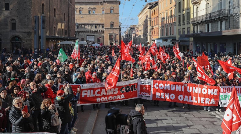 People gather on the occasion of a general strike called by the CGIL (Italian General Confederation of Labour) trade union to protest against the budget law in Bologna, Italy, Friday, Dec. 12, 2025. (Guido Calamosca/LaPresse via AP)