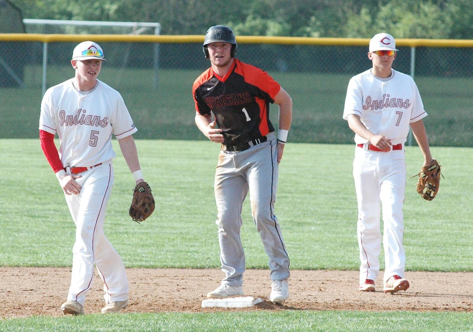 Waynesville’s Drake Stiles (1) is safe at second base between Carlisle’s Kole Larison (5) and Jesse Rutherford (7) on Monday at Sam Franks Field in Carlisle. Waynesville won the Southwestern Buckeye League Buckeye Division baseball game 7-0. RICK CASSANO/STAFF