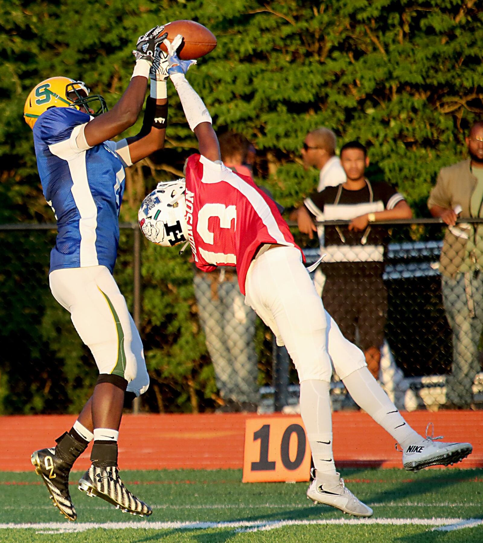 The West’s Domonick Johnson of Hamilton goes up for a ball intended for the East’s Khadim Fall of Sycamore on Thursday night in the Southwestern Ohio Football Coaches Association Ron Woyan East-West All-Star Game at Kings. CONTRIBUTED PHOTO BY E.L. HUBBARD