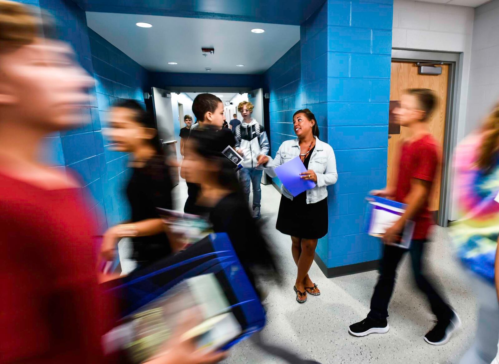 Intervention Specialist Dawn Schneider helps students find their classes in the hallway on the first day of classes at the new Fairfield Freshman School Tuesday, Sept. 5 in Fairfield. NICK GRAHAM/STAFF