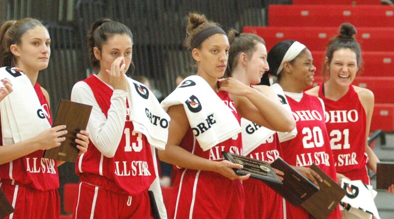 Franklin’s Layne Ferrell (21) shares a laugh with Walnut Hills’ Kennedi Myles (20) during Friday night’s Ohio High School Basketball Coaches Association North-South Division I-II All-Star festivities at Denison University’s Mitchell Center. Ferrell had 11 points and eight rebounds, while Myles had nine points and 13 boards, as the South won 131-77. RICK CASSANO/STAFF