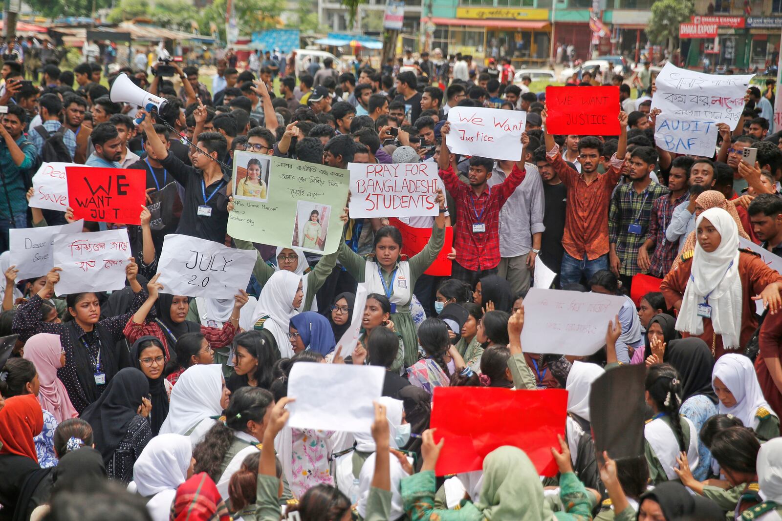 Students shout slogans during a protest near the site of the Monday crash of a Bangladesh air force training jet into a school, demanding accountability, compensation for victims' families and the halt of training flights, in Dhaka, Bangladesh, Tuesday, July 22, 2025. (AP Photo/ Mehedi Hasan)