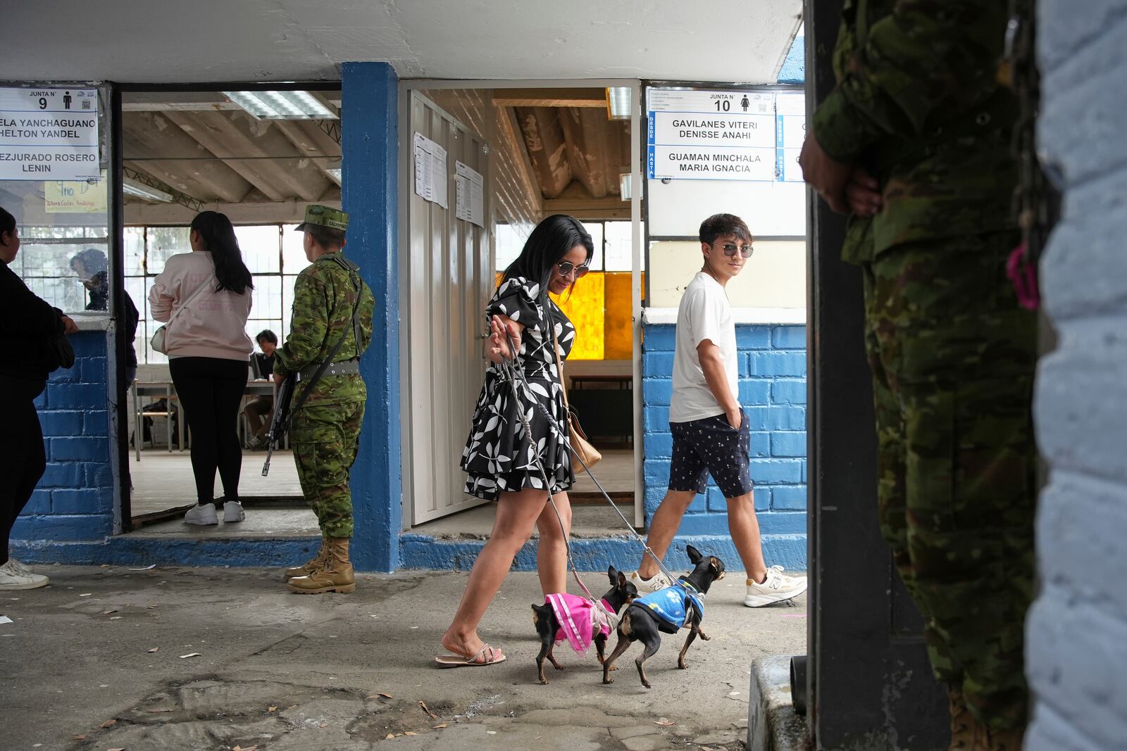 Voters arrive to a polling station the presidential election runoff in Quito, Ecuador, Sunday, April 13, 2025. (AP Photo/Carlos Noriega)