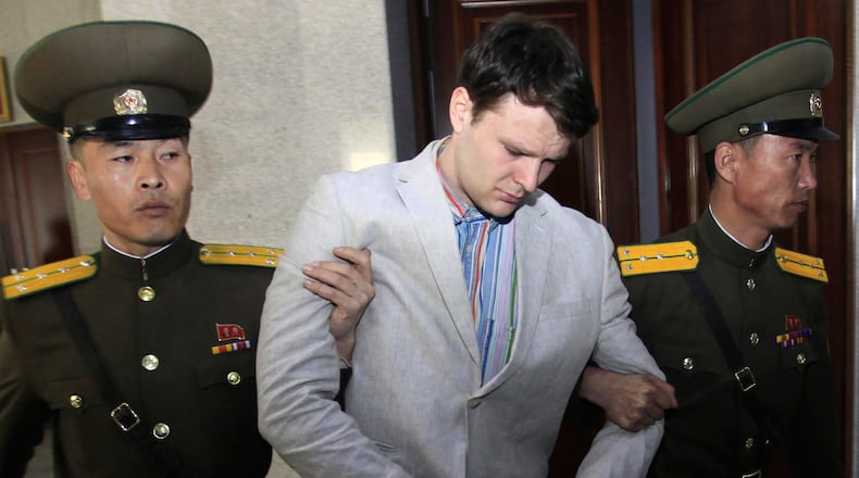FILE - American student Otto Warmbier, center, is escorted at the Supreme Court in Pyongyang, North Korea on March 16, 2016. (AP Photo/Jon Chol Jin, File)