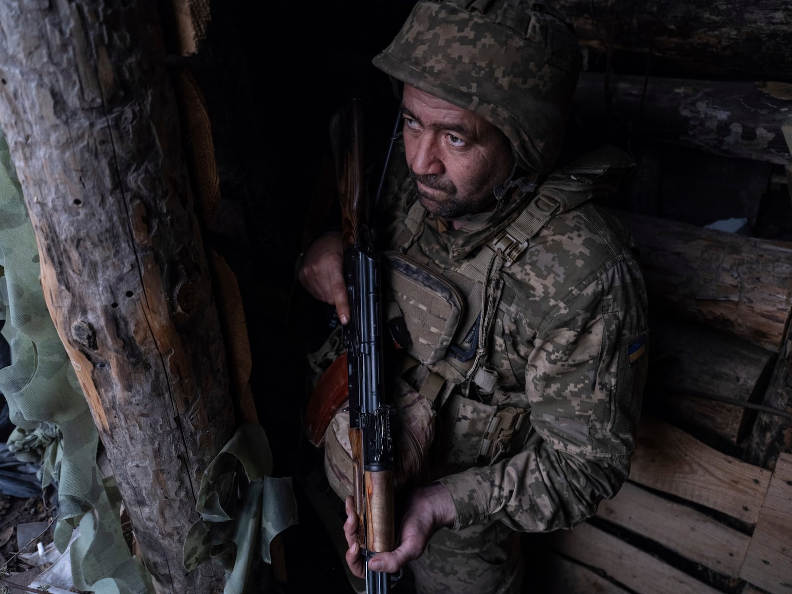 In this photo provided by Ukraine's 93rd Kholodnyi Yar Separate Mechanized Brigade press service, a soldier looks out of a shelter on the anti-drone firing position in Kostyantynivka, the site of the heavy battles with the Russian troops in the Donetsk region, Ukraine, Thursday, April 24, 2025. (Iryna Rybakova/Ukraine's 93rd Mechanized Brigade via AP).