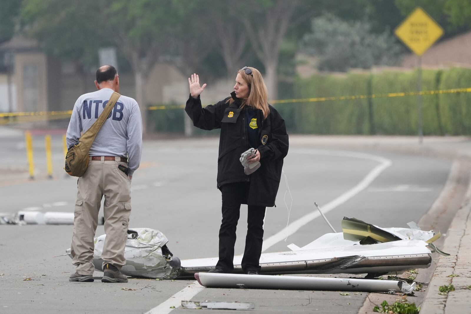 Investigators work at the site of a plane crash Friday, May 23, 2025, in San Diego. (AP Photo/Gregory Bull)