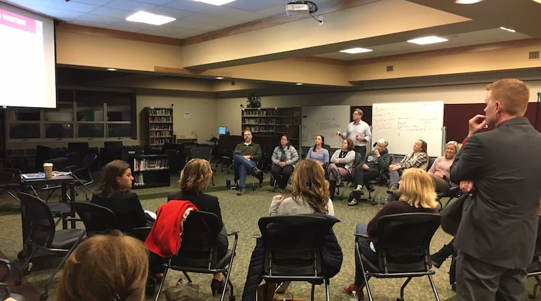 Lakota Schools Superintendent Matt Miller (right) listens Monday evening as two dozen school district residents, staffers and others discuss the creation of a new strategic plan for the Butler County school system. The “community conversation” meeting at Lakota Plains Junior School was the latest in a series of public gatherings designed to collect public input.