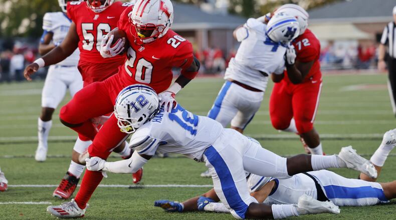 Fairfield's Juseters Fataki (20) runs the ball in for a touchdown defended by Hamilton's Donovan Ripley (12) during their football game Friday, Sept. 24. 2021 in Fairfield. NICK GRAHAM / STAFF
