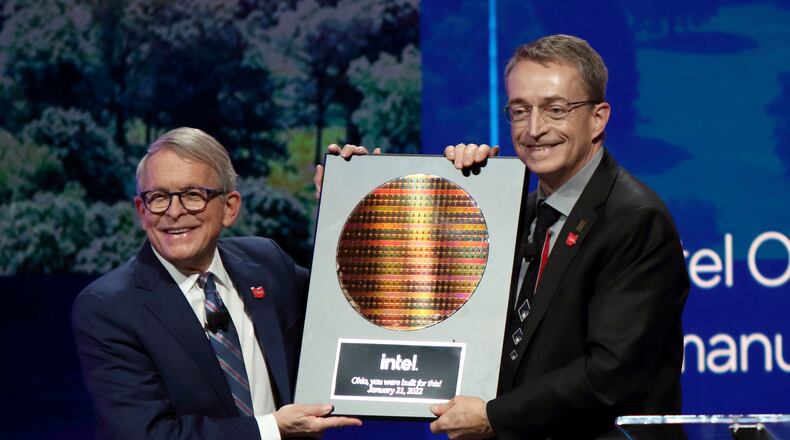 FILE - Intel CEO Patrick Gelsinger, right, presents Ohio Gov. Mike DeWine with a silicon wafer during on Jan. 21, 2022 in Newark, Ohio, where Intel announced it will invest $20 billion to build two computer chip factories on a 1,000-acre site in Licking County, Ohio, just east of Columbus. Intel said Thursday it will invest $50 million in Ohio higher education initiatives targeting the semiconductor industry, and partner with the U.S. National Science Foundation which is providing an additional $50 million for research grants nationally. (AP Photo/Paul Vernon, File)