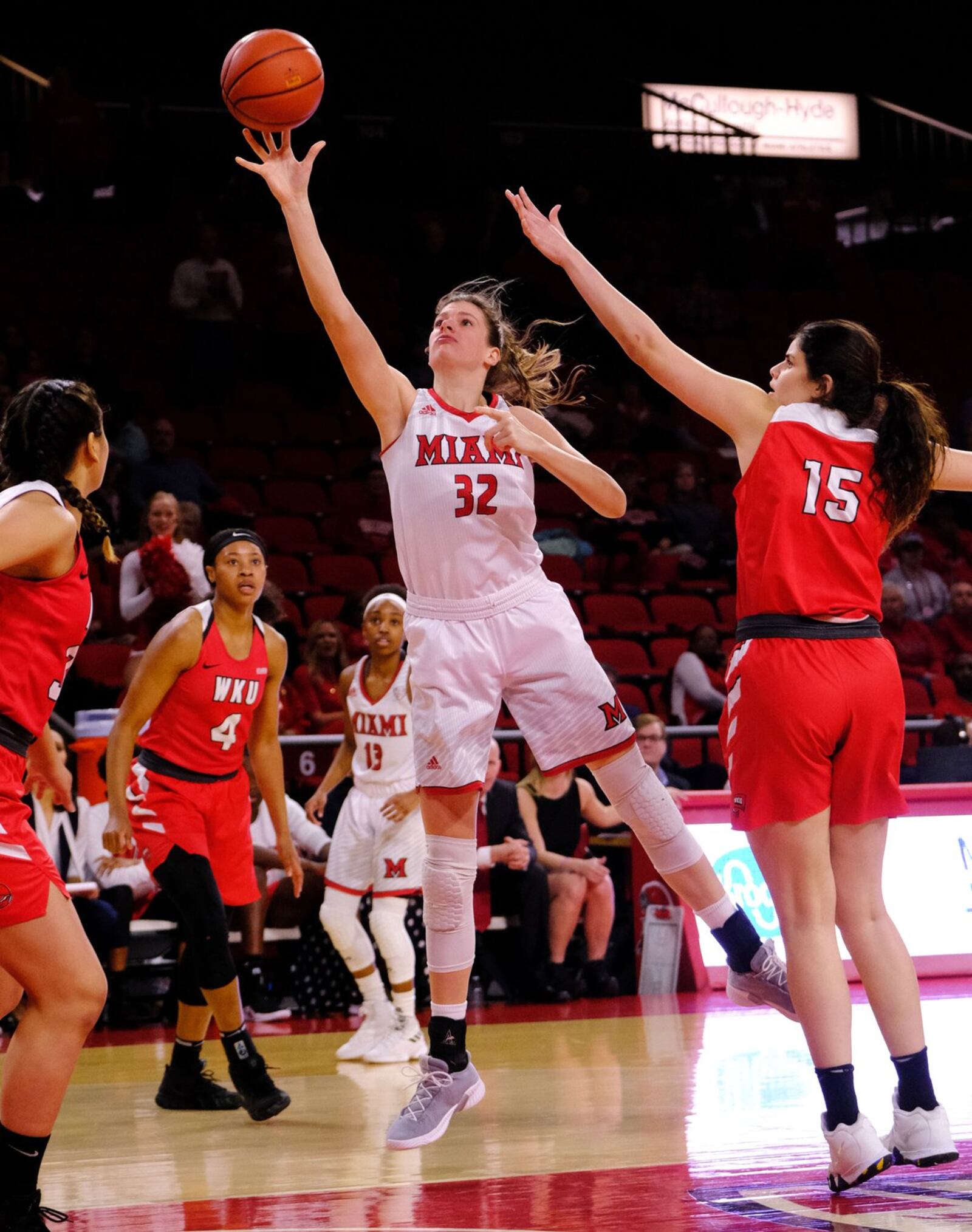 Miami University’s Savannah Kluesner (32) gets a shot off past Western Kentucky’s Raneem Elgedawy (15) during Thursday night’s WNIT game at Millett Hall in Oxford. WKU won 67-63. SCOTT KISSELL/MIAMI UNIVERSITY