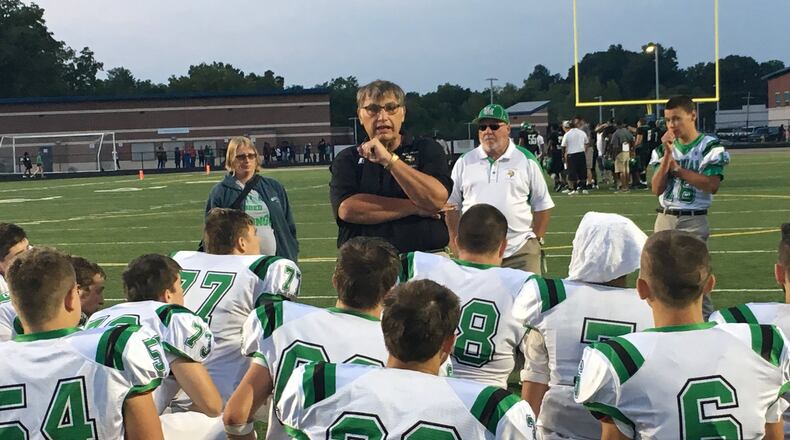 New Miami coach John Singleton talks to his team after the Vikings dropped a 20-6 decision to Gamble Montessori on Saturday night at Woodward. RICK CASSANO/STAFF