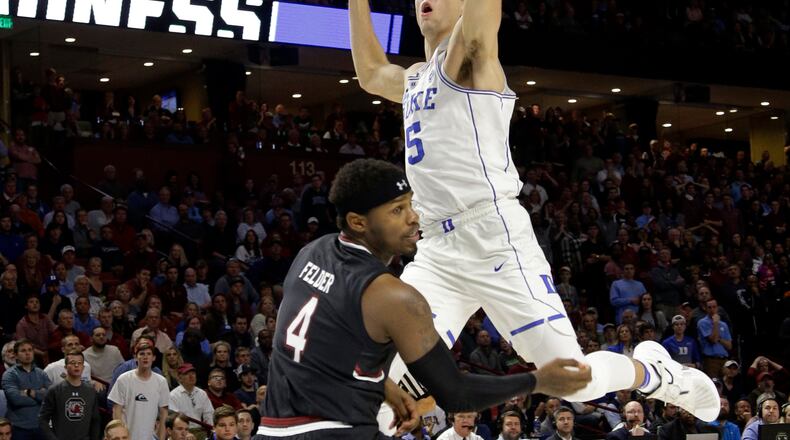Duke’s Luke Kennard (5) is fouled by South Carolina’s Rakym Felder (4) during the second half in a second-round game of the NCAA men’s college basketball tournament in Greenville, S.C., Sunday, March 19, 2017. (AP Photo/Chuck Burton)