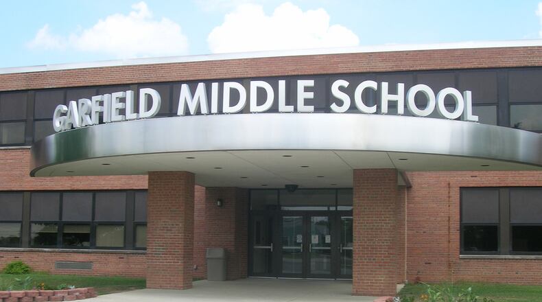 Hamilton City Schools officials say a Garfield Middle School teacher has been placed on paid leave as police and district officials “review the teacher’s conduct.”