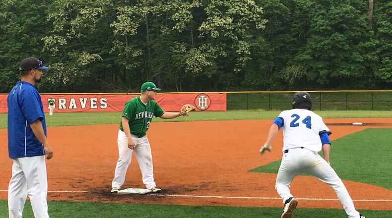 Cincinnati Christian’s Mitchell Smith (24) heads back to third base as New Miami’s Dalton Garrett awaits the throw during a Division IV district semifinal at Indian Hill last May. That’s CCS coach Curtus Moak watching the play. RICK CASSANO/STAFF