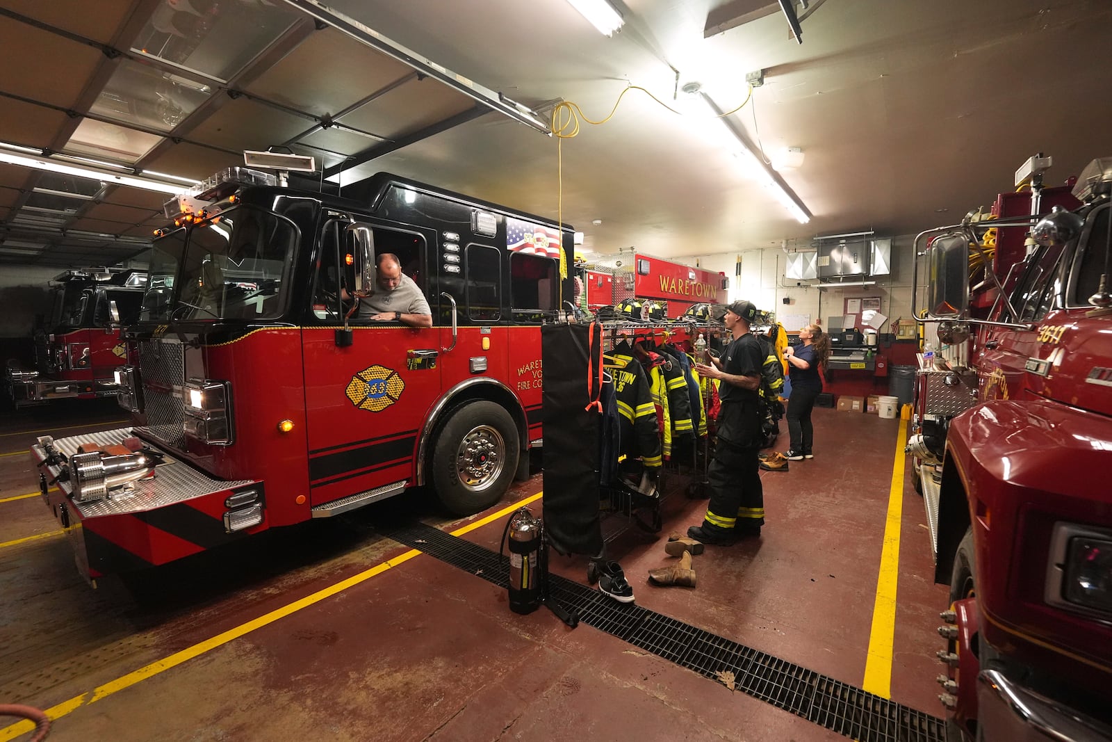 Waretown Volunteer Fire Company firefighters prepare to respond to a wildfire on Tuesday, April 22, 2025, in Waretown, N.J. (AP Photo/Chris Szagola)