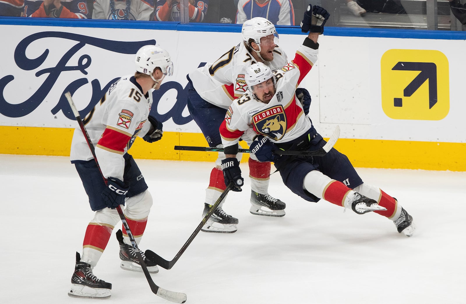 Florida Panthers' Brad Marchand (63) celebrates his game-winning goal against the Edmonton Oilers with Jesper Boqvist (70) and Anton Lundell (15) during the second overtime period in Game 2 of the NHL Stanley Cup final in Edmonton, Friday, June 6, 2025.(Jason Franson/The Canadian Press via AP)