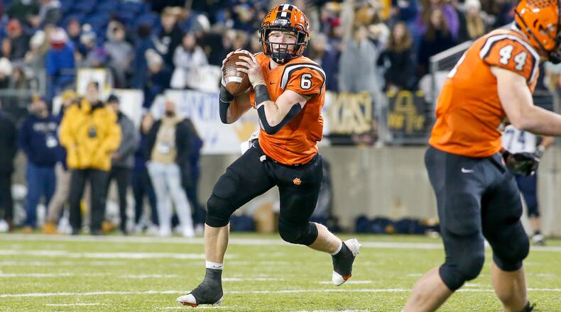 Versailles quarterback Carson Bey rolls out during the Division V state championship game vs. Kirtland on Dec. 5, 2021. Bey, a linebacker on defense, on Tuesday was named co-defensive player of the year in Ohio for Division V. Michael Cooper/CONTRIBUTED