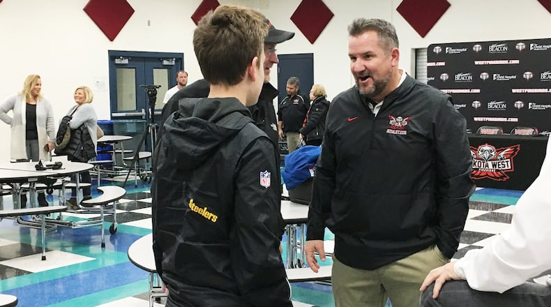 New Lakota West High School football coach Tom Bolden was the center of attention Tuesday in the school cafeteria during a meet-the-coach gathering. RICK CASSANO/STAFF