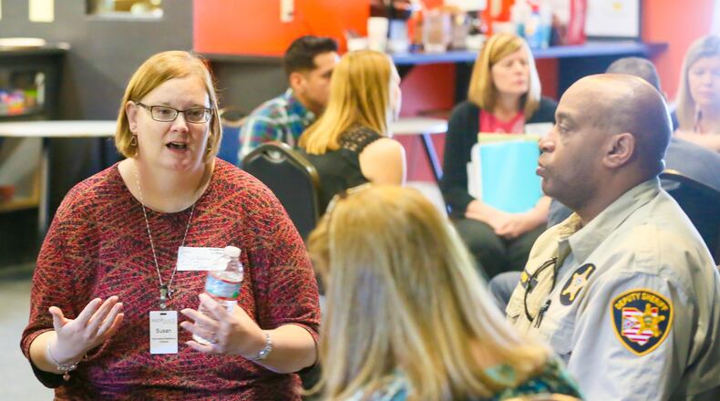 Lakota School Board member Lynda O’Connor and other listen as Susan Fisher, of the MidPointe Library System, speaks during a special meeting with youth organization leaders held at the Edge Teen Center in Liberty Twp. Wednesday, May 31, 2017. GREG LYNCH / STAFF