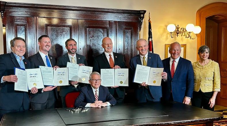 Ohio Gov. Mike DeWine signs a series of bills meant to address rising property taxes in Ohio on Dec. 19, 2025. Photo by Avery Kreemer.