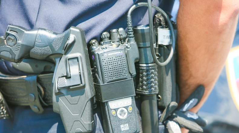 Fairfield Police officer Scott Webb displays his radio outside the police station, Wednesday, Aug. 2, 2017. Butler County officials and police and fire departments across the county are looking at a $19.2 million price tag to replace parts of the 800 MHz communications systems, including the radios first responders carry. GREG LYNCH / STAFF