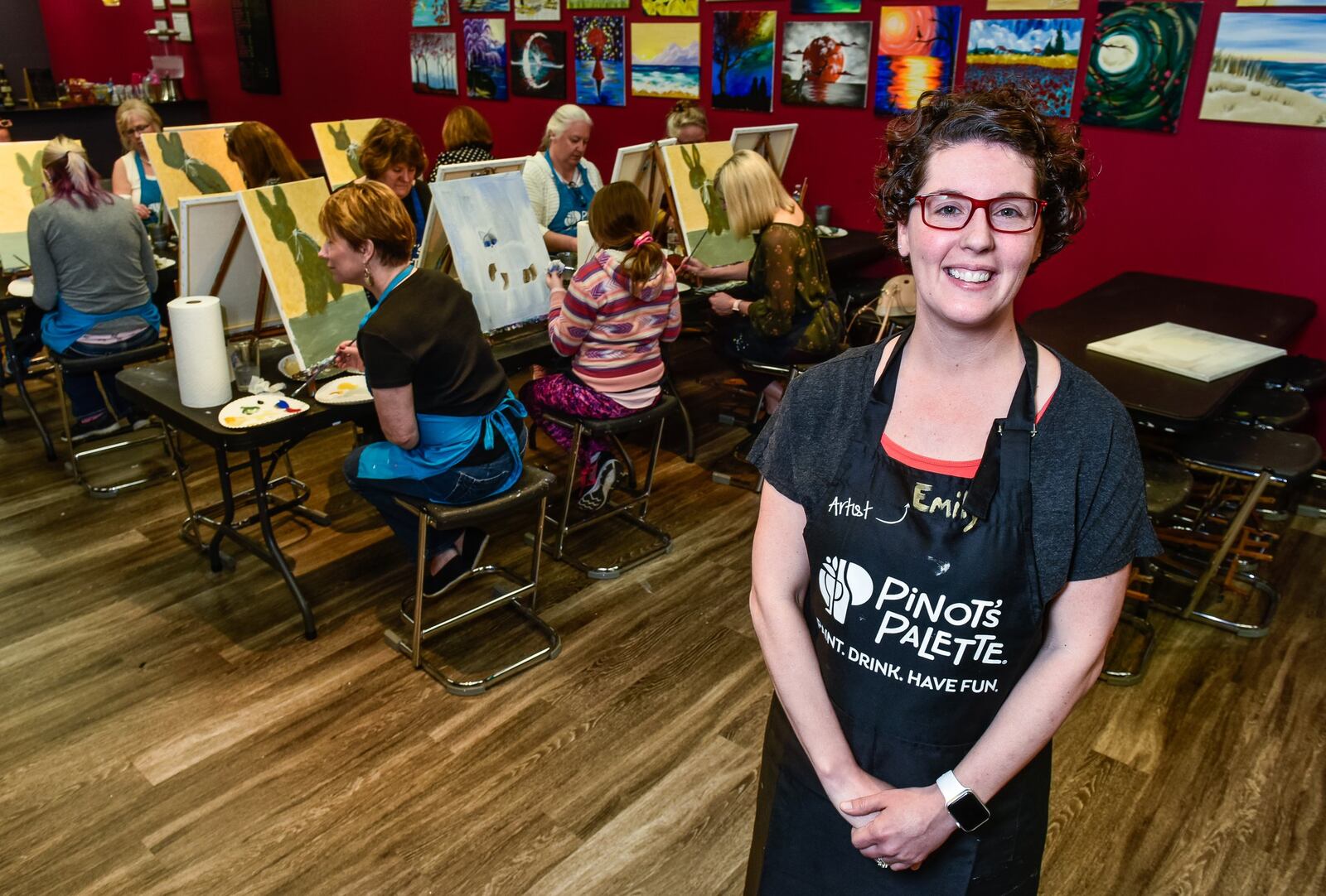 Owner Emily Davis stands in her newly opened Pinot’s Palette location on Tylers Corner in West Chester Township Monday, April 8, 2019. The business is a place to gather with friends with a glass of wine or beer while a local artist guides you through painting your own piece of art on a canvas. NICK GRAHAM/STAFF
