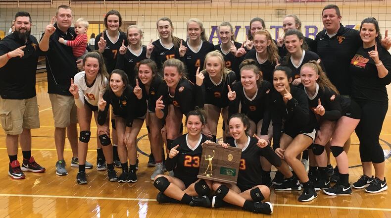 The Fenwick Falcons pose for a photo Saturday afternoon after defeating Roger Bacon 3-2 to capture a Division II regional volleyball championship at Vandalia Butler’s Student Activity Center. RICK CASSANO/STAFF