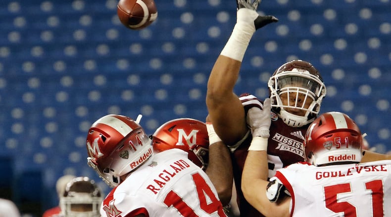 ST. PETERSBURG, FL - DECEMBER 26: Defensive lineman Braxton Hoyett #95 of the Mississippi State Bulldogs tries to block a pass by quarterback Gus Ragland #14 of the Miami (Oh) Redhawks during the second quarter in the St. Petersburg Bowl at Tropicana Field on December 26, 2016, in St. Petersburg, Florida. (Photo by Joseph Garnett, Jr. /Getty Images)
