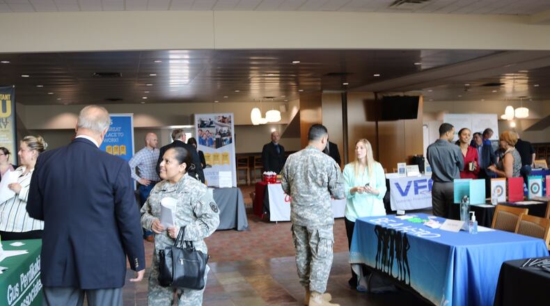 Participants and company officials talk during RecruitMilitary’s All-Veteran Career Fair in 2016 in southwest Ohio. CONTRIBUTED