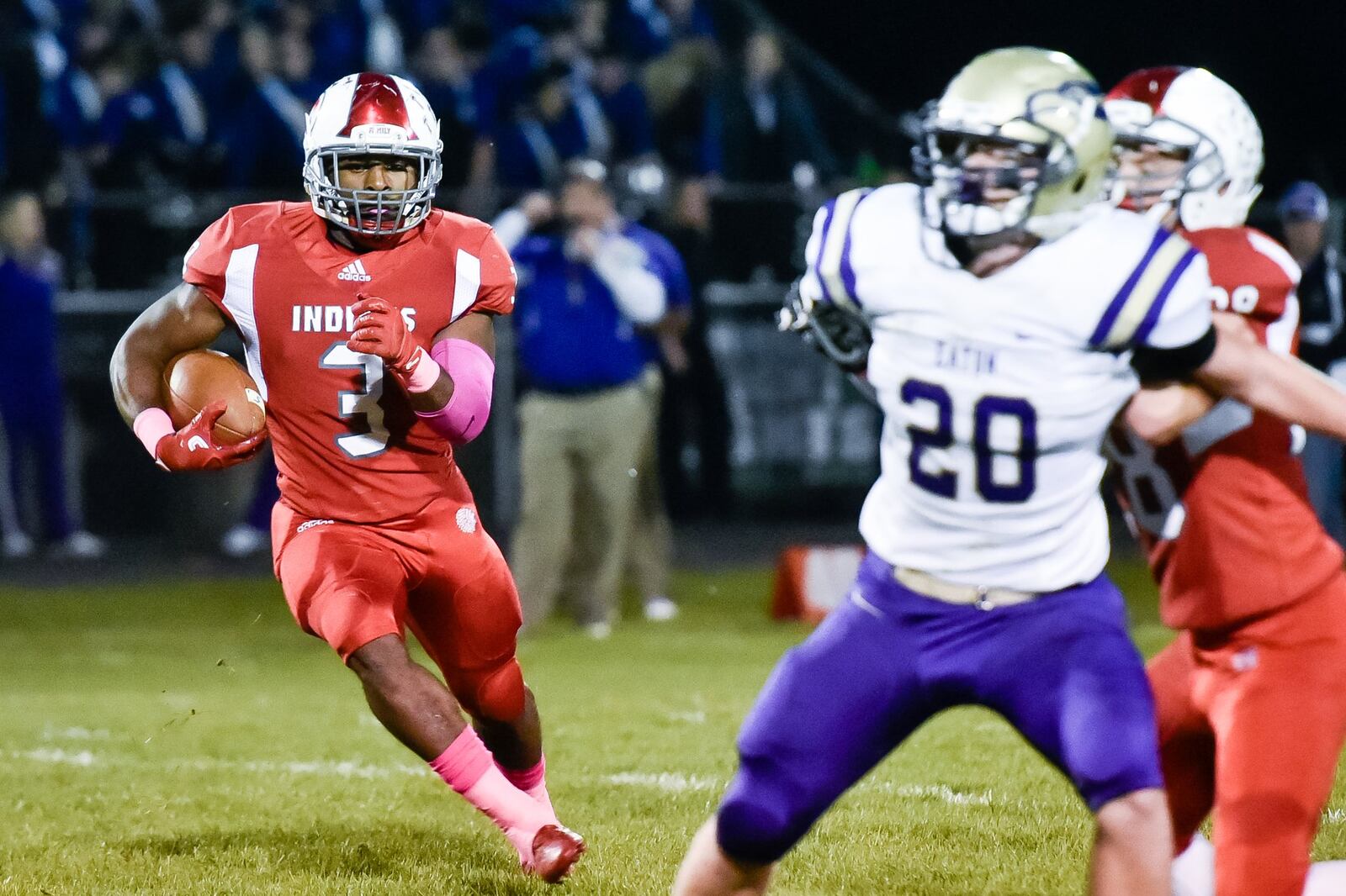 Carlisle’s D.J. Chambers looks for room to run past Eaton’s Aaron Tolliver (20) during Thursday night’s game at Laughlin Field in Carlisle. NICK GRAHAM/STAFF
