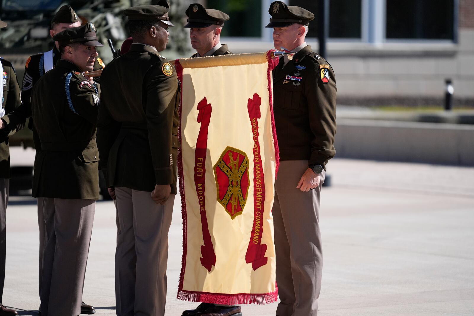 Members of the Army military change a flag from Fort Moore to Fort Benning during a ceremony at Fort Benning, honoring new namesake of World War I Fred Benning on Wednesday, April 16, 2025, in Fort Benning, Ga. (AP Photo/Brynn Anderson)