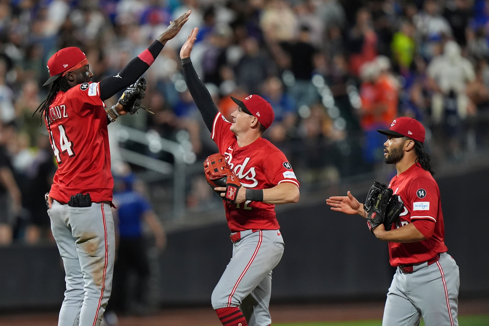 Cincinnati Reds' Elly De La Cruz, left, celebrates with Austin Hays, center, and Connor Joe after a baseball game against the New York Mets Friday, July 18, 2025, in New York. (AP Photo/Frank Franklin II)